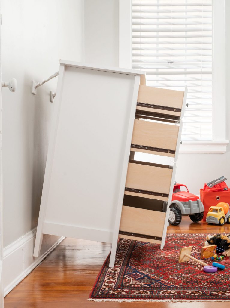 Anchored dresser tipping away from wall but not falling